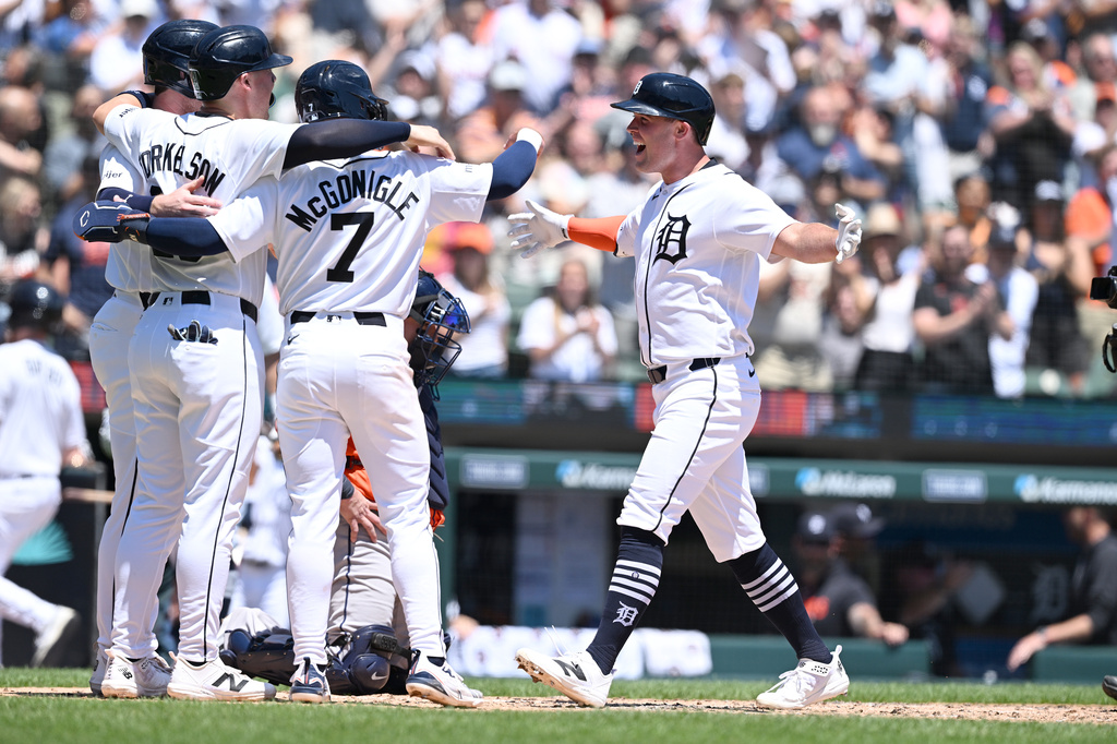 Detroit Tigers' Kerry Carpenter, right, celebrates at home plate with teammates Kevin McGonigle (7) Spencer Torkelson (second from left) and Colt Keith, after hitting a grand slam home run against the Houston Astros in the third inning of a baseball game, Saturday, June 27, 2026, in Detroit. (AP Photo/Lon Horwedel)