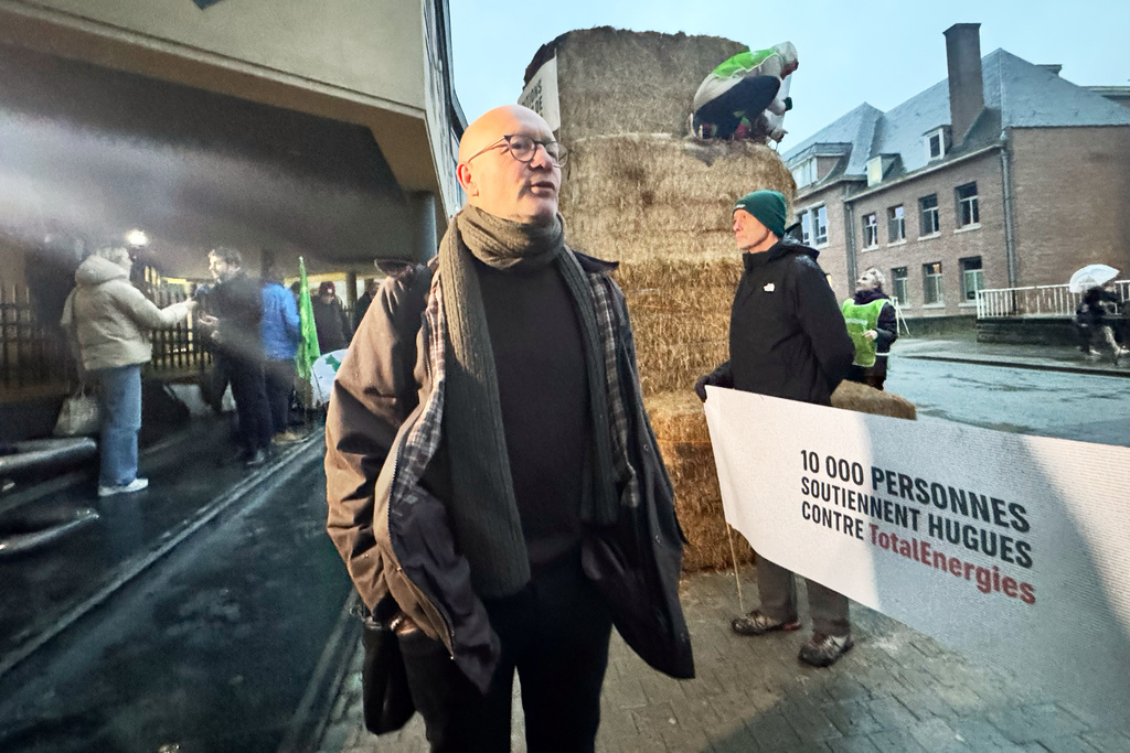 Belgian farmer Hugues Falys stands outside a court house as French oil giant TotalEnergies is on trial, accused by Falys and three environmental groups of bearing responsibility for climate change, Wednesday, Nov. 19, 2025 in Tournai, Belgium. (AP Photo/Sylvain Plazy)