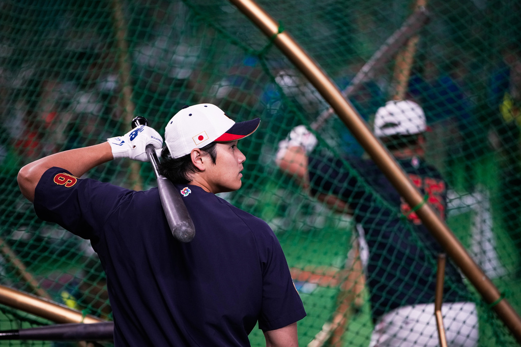 Japan's Shohei Ohtani, left, practices in the nets before the start of a World Baseball Classic Pool C game between Japan and Taiwan Friday, March 6, 2026 in Tokyo. (AP Photo/Louise Delmotte)