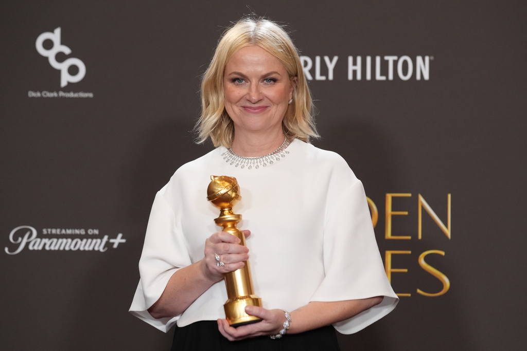 Amy Poehler poses in the press room with the award for best podcast for "Good Hang with Amy Poehler during the 83rd Golden Globes on Sunday, Jan. 11, 2026, at the Beverly Hilton in Beverly Hills, Calif. (AP Photo/Chris Pizzello)