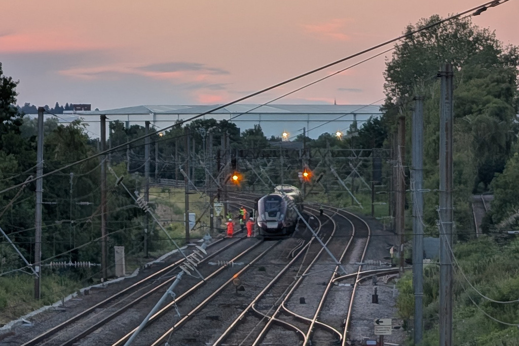 Emergency personnel work on a train on the tracks outside Bedford, England, after a train from Corby to London St. Pancras and another from Nottingham to London St. Pancras, collided on Friday June 19, 2026. (Jamie Lashmar/PA via AP)