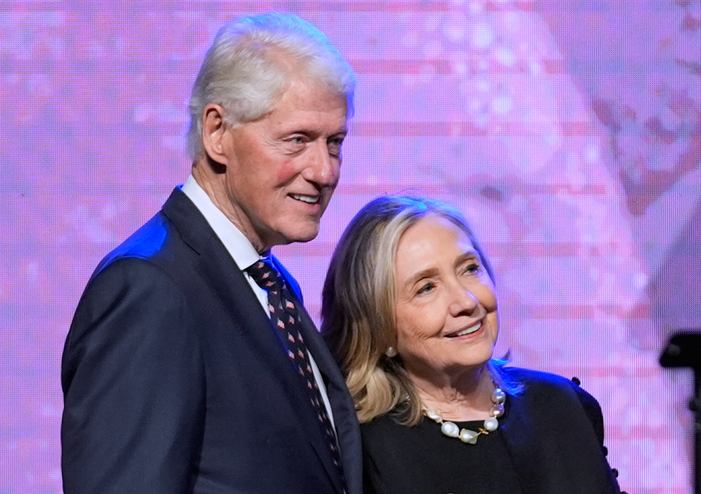 FILE - Former President Bill Clinton, left, and former Secretary of State Hillary Clinton listen as Vice President Kamala Harris delivers a eulogy for U.S. Rep.†Sheila Jackson Lee, Aug. 1, 2024, in Houston. (AP Photo/LM Otero, File)