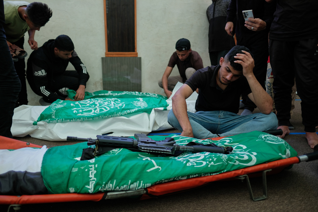 Palestinians mourn over the bodies of Hamas militant Imad Isleim, foreground, his wife and daughter, who were killed in an Israeli military strike, during their funeral at Al-Shafi'i Mosque in Gaza City, Thursday, May 28, 2026. (AP Photo/Jehad Alshrafi) CORRECTION: Corrects surname from al-Salem to Isleim
