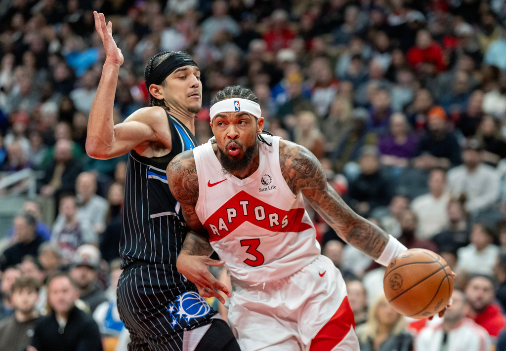 Toronto Raptors forward Brandon Ingram (3) drives against Orlando Magic guard Anthony Black (left) during first half of an NBA game in Toronto on Monday Dec. 29, 2025. THE (Frank Gunn/The Canadian Press via AP)