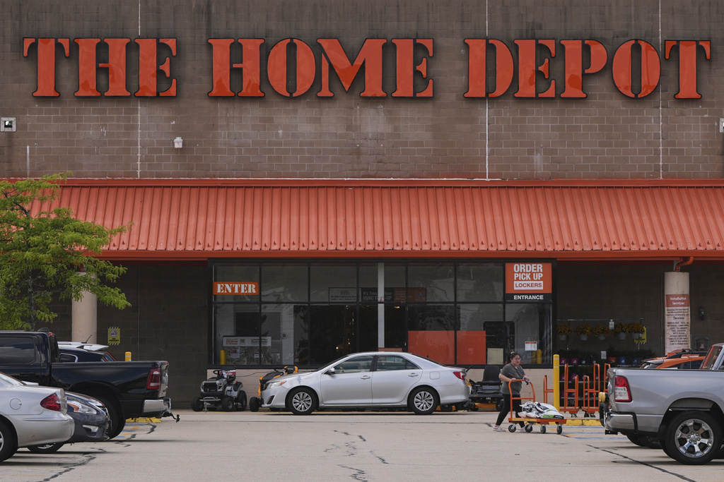 FILE -A shopper leaves a Home Depot store, Thursday, Aug. 14, 2025, in Manchester, N.H. (AP Photo/Charles Krupa, File)