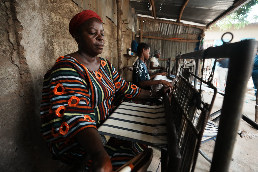 Chabi Baké, a mother of five, weaves in Parakou, northern Benin, Saturday, May 16, 2026. (AP Photo/Sunday Alamba)