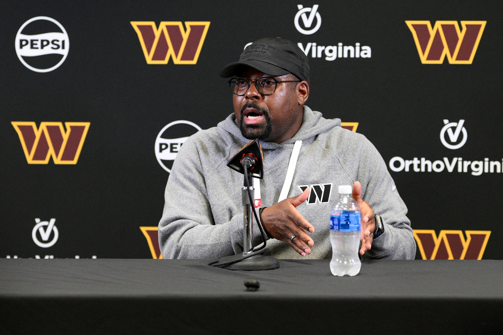 File - Washington Commanders defensive coordinator Joe Whitt Jr. talks to the media before NFL football practice June 4, 2025, in Ashburn, Va. (AP Photo/Nick Wass, File)