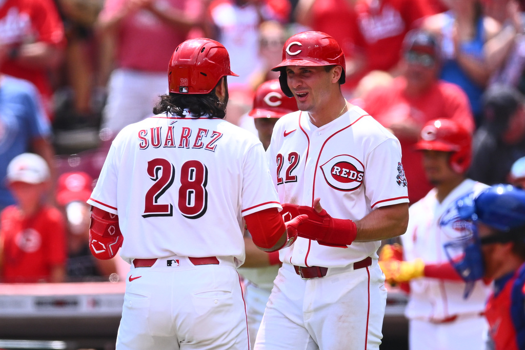 Cincinnati Reds' Eugenio Suárez, left, celebrates with JJ Bleday, right, after hitting a two-run home run during the third inning of a baseball game against the Chicago Cubs in Cincinnati, Sunday, July 12, 2026. (AP Photo/Ben Jackson)