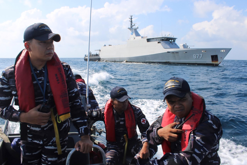 In this photo released by Makassar Search and Rescue Office on Sunday, July 19, 2026, Indonesian Navy personnel cruises on a rubber boat during a search for victims after a passenger boat sank in the waters near Balaloho Island in South Sulawesi, Indonesia. (Makassar SAR Office via AP)