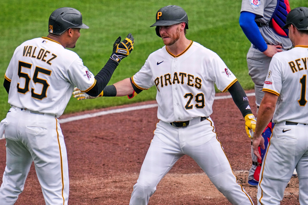 Pittsburgh Pirates' Ryan O'Hearn (29) celebrates with Esmerlyn Valdez (55) and Bryan Reynolds, right, after hitting a grand slam off Chicago Cubs pitcher Jameson Taillon during the third inning of a baseball game in Pittsburgh, Sunday, July 26, 2026. (AP Photo/Gene J. Puskar)