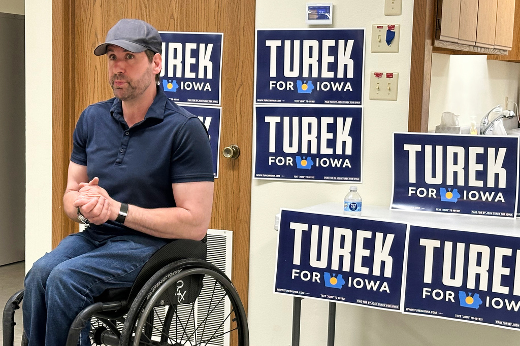 Iowa state Rep. Josh Turek, a Democratic candidate for U.S. Senate, talks to a voter in Ellston, Iowa, Wednesday, May 27, 2026. (AP Photo/Hannah Fingerhut)