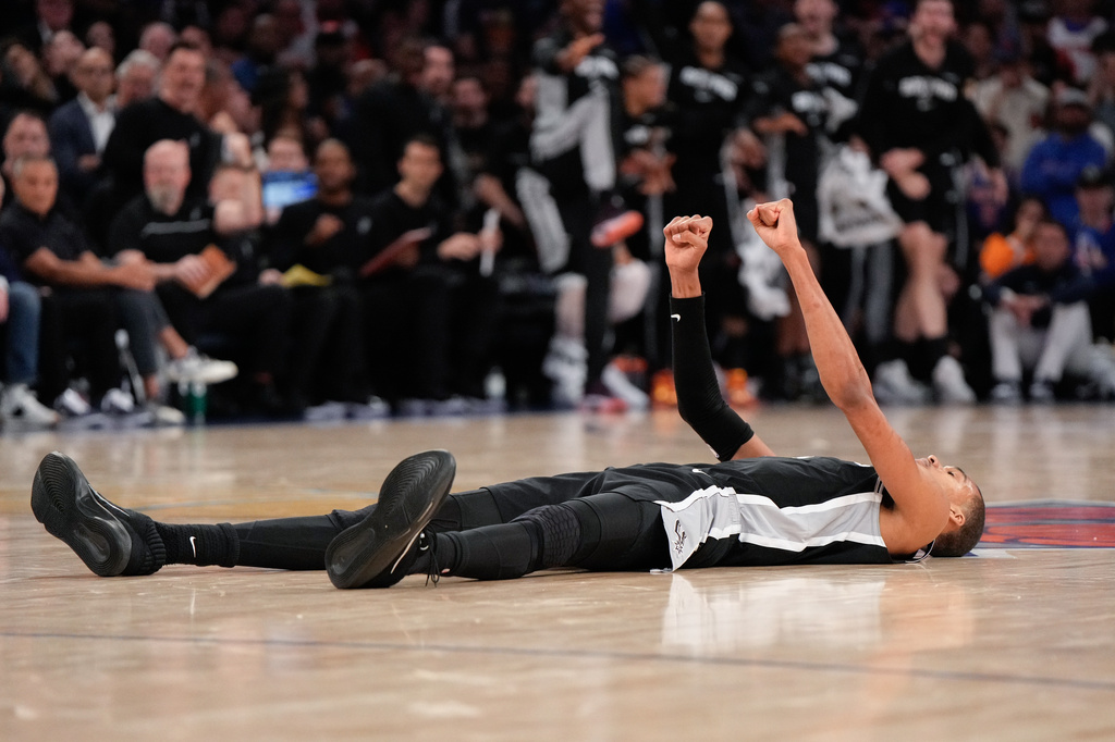 San Antonio Spurs forward Victor Wembanyama lies on the court after a shot during second half of Game 3 of the NBA Finals basketball series against the New York Knicks, Monday, June 8, 2026, in New York. (AP Photo/Ross D. Franklin)
