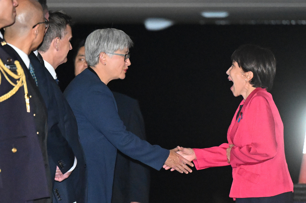 Prime Minister of Japan Sanae Takaichi, right, is greeted by Australian Foreign Minister Penny Wong in Canberra, Australia, Sunday, May 3, 2026. (Lukas Coch/AAP Image via AP)