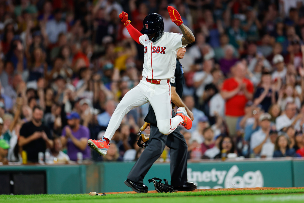 Boston Red Sox's Ceddanne Rafaela leaps over equipment after scoring during the sixth inning of a baseball game against the Arizona Diamondbacks Monday, Aug. 17, 2026, in Boston. (AP Photo/CJ Gunther)