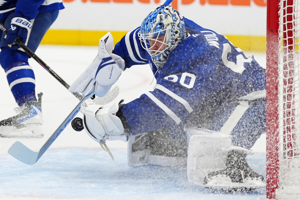 Toronto Maple Leafs goaltender Joseph Woll (60) makes a save against the New Jersey Devils during the first period of an NHL hockey game in Toronto, Tuesday Dec. 30, 2025. (Frank Gunn/The Canadian Press via AP)