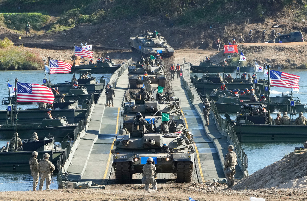 FILE - South Korean Army K1E1 tanks cross a floating bridge on the Namhan River during a joint river-crossing drill between South Korea and the United States in Yeoju, South Korea, on Oct. 20, 2023. (AP Photo/Ahn Young-joon, File)