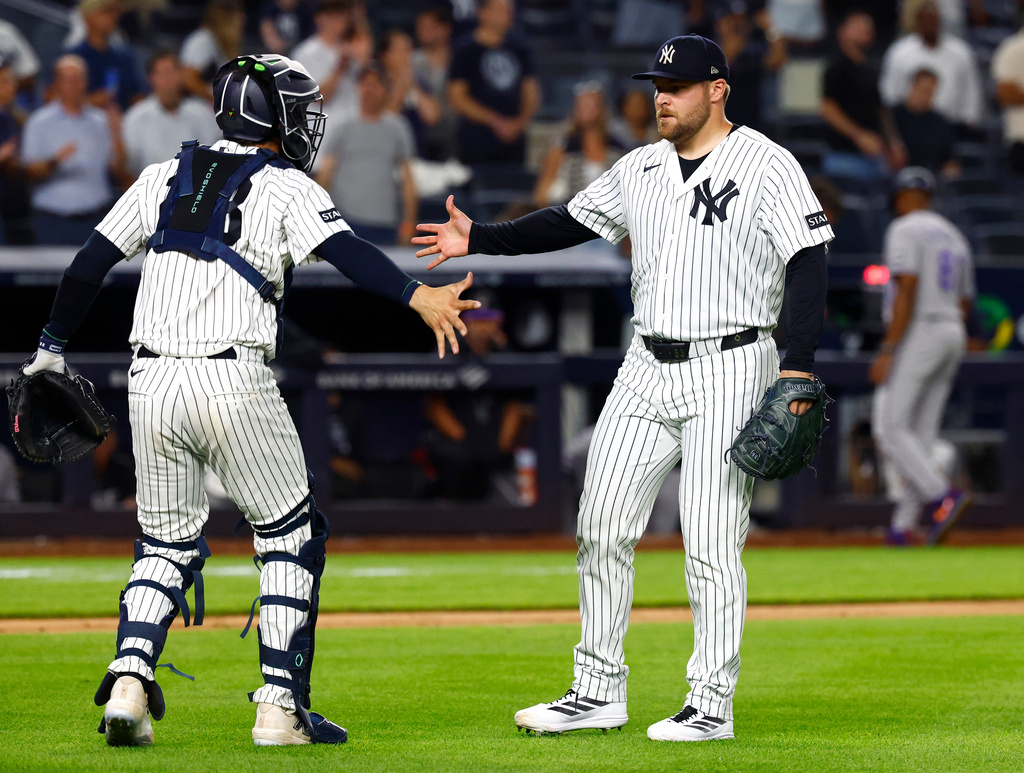 New York Yankees catcher Austin Wells, left, and pitcher David Bednar, right, shakes hands after defeating the Colorado Rockies, Tuesday, Sept. 8, 2026, in New York. (AP Photo/Noah K. Murray)