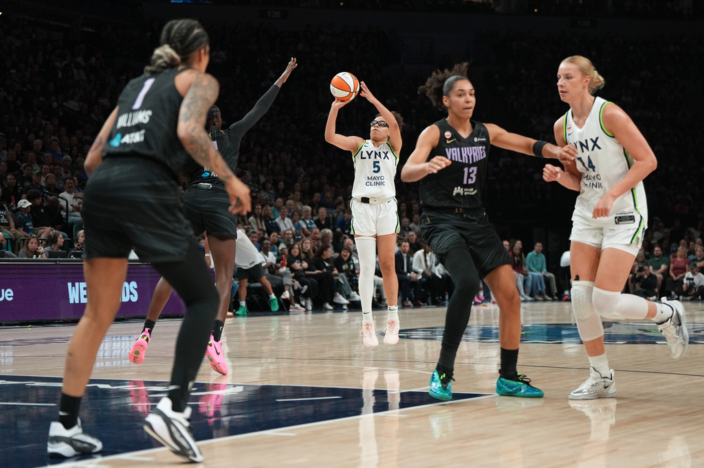 Minnesota Lynx guard Olivia Miles (5) goes up to shoot during the first half of a WNBA basketball game against the Golden State Valkyries, Monday, Aug. 24, 2026, in Minneapolis. (AP Photo/Abbie Parr)