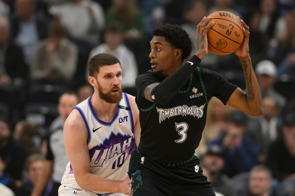Minnesota Timberwolves forward Jaden McDaniels (3) posts up against Utah Jazz guard Svi Mykhailiuk (10) during the first half of an NBA basketball game, Monday, Nov. 10, 2025, in Salt Lake City. (AP Photo/Tyler Tate)