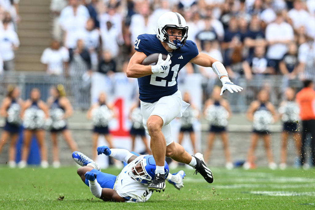 Penn State running back Carson Hansen (21) eludes a Buffalo defender during the second quarter of an NCAA college football game, Saturday, Sept. 19, 2026, in State College, Pa. (AP Photo/Barry Reeger)