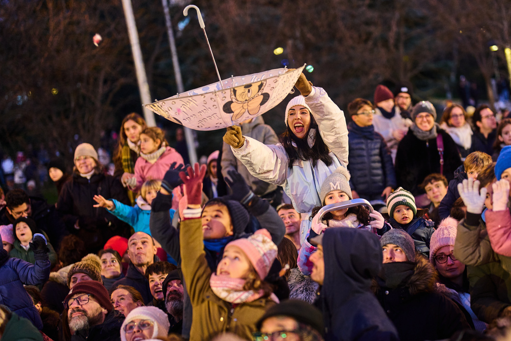 People attend the traditional "Cabalgata de Reyes" parade in Madrid, Spain, Monday, Jan. 5, 2026, as part of the festivities marking the Catholic feast of Epiphany. (AP Photo/Bernat Armangue)