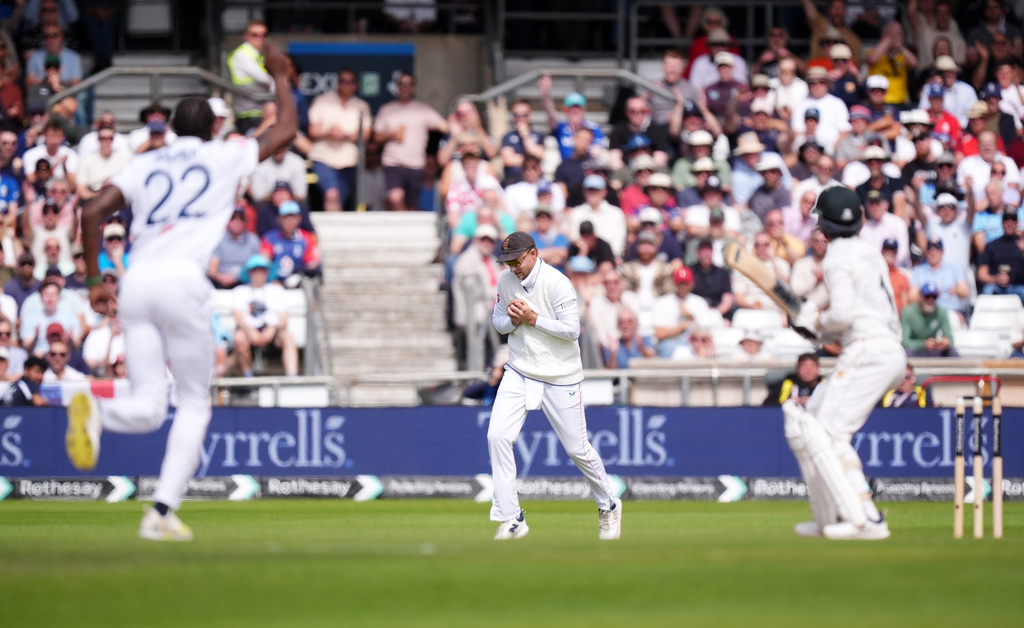 England's Joe Root, center, catches out Pakistan's Azan Awais from the bowling of England's Jofra Archer, left, on day three of the first Test match between England and Pakistan in Leeds, England, Friday Aug. 21, 2026. (Mike Egerton/PA via AP)