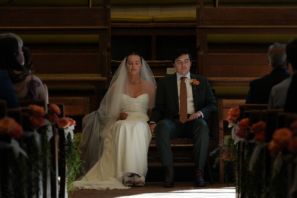 Emily Philbrook and Benjamin Barger hold a moment of silence during their traditional Quaker wedding at Arch Street Meeting House in Philadelphia on Oct. 3, 2025. (AP Photo/Luis Andres Henao)