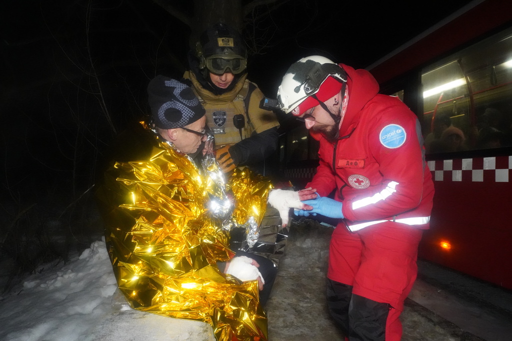 A paramedic gives first aid to a resident who was injured in a Russian airstrike in Kharkiv, Ukraine, Saturday, Jan. 24, 2026. (AP Photo/Andrii Marienko)