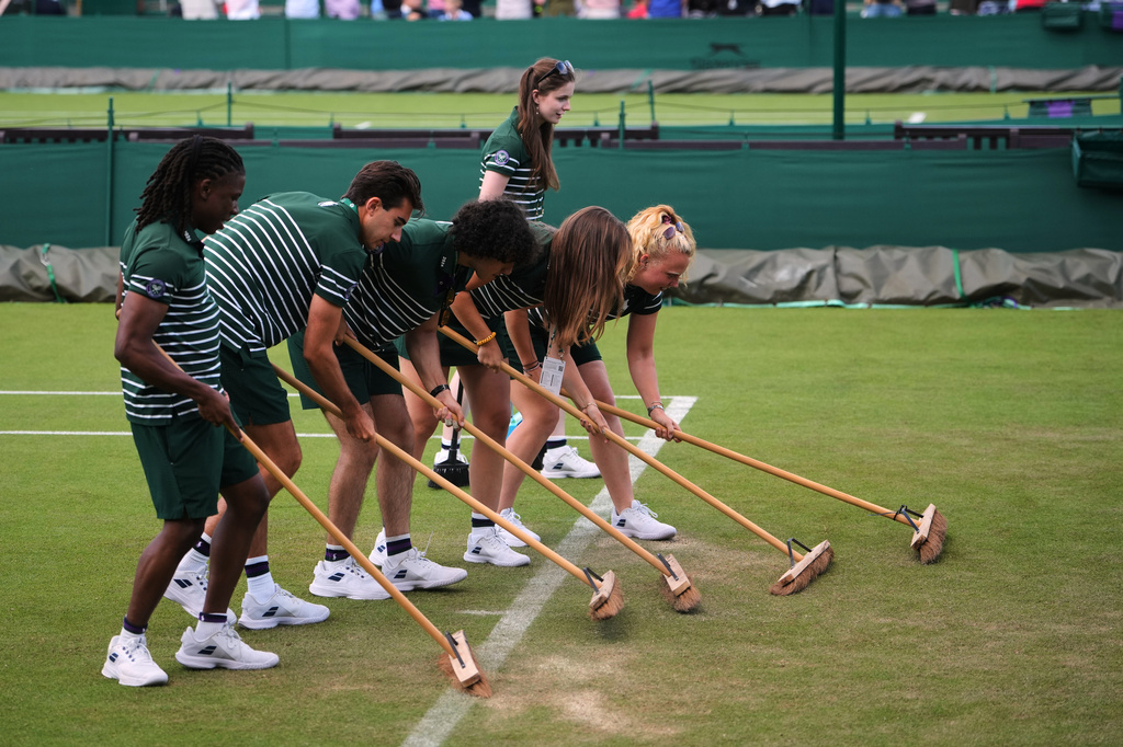 Ground staff works on the court on day two of the Wimbledon Tennis Championships in London, Tuesday, June 30, 2026.(AP Photo/Kin Cheung)