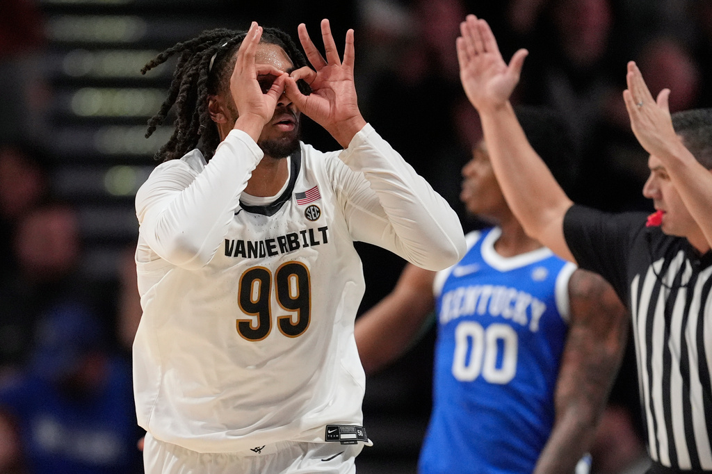 Vanderbilt forward Devin McGlockton (99) celebrates a three point basket during the first half of an NCAA college basketball game against Kentucky, Tuesday, Jan. 27, 2026, in Nashville, Tenn. (AP Photo/George Walker IV)