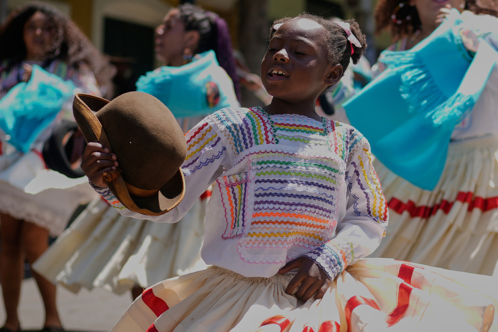 A young member of the Afro-Bolivian community dances the “saya,” a traditional dance performed with drums and chants, as part of the celebrations to mark the upcoming National Day of Afro-Bolivian people, in La Paz, Bolivia, Friday, Sept. 19, 2025. (AP Photo/Juan Karita)