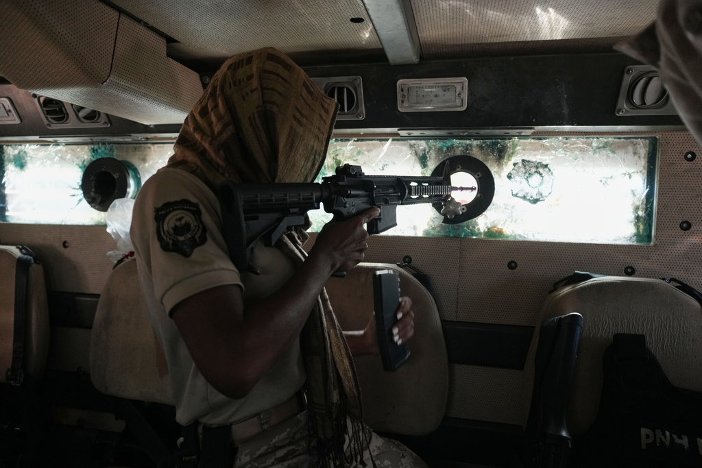 Police in an armored vehicle patrol a gang-controlled area of Port-au-Prince, Haiti, Monday, Jan. 19, 2026. (AP Photo/Odelyn Joseph)