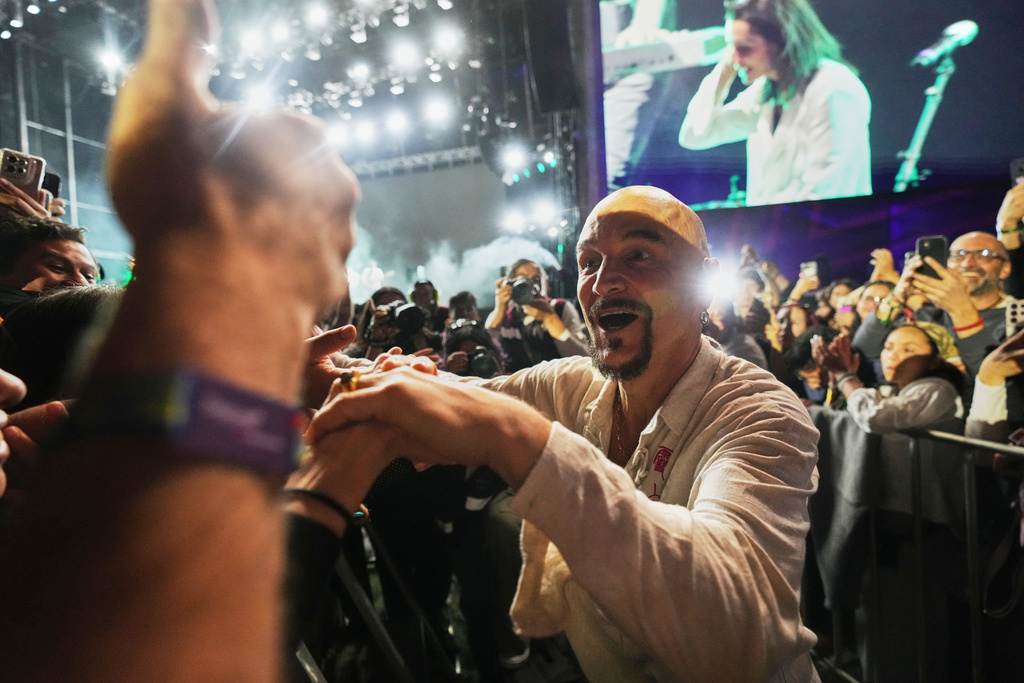 Tim Booth, of the English rock band James, approaches fans during his band performance at the Corona Capital music festival in Mexico City, Sunday, Nov. 16, 2025. (AP Photo/Claudia Rosel)