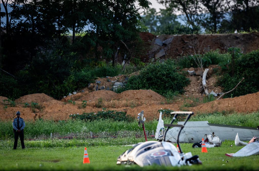 Authorities investigate a crash between a Pennsylvania State Police helicopter and a small plane at the Carlisle airport in Carlisle, Pa. Wednesday, Aug. 19, 2026. (Sean Simmers/The Patriot-News via AP)