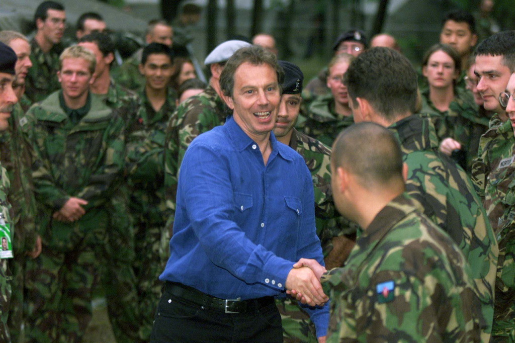 FILE - British Prime Minister Tony Blair, greets British KFOR troops at the KFOR headquarters in Pristina after his arrival here late Friday evening July 30, 1999. (AP Photo/David Brauchli, File)