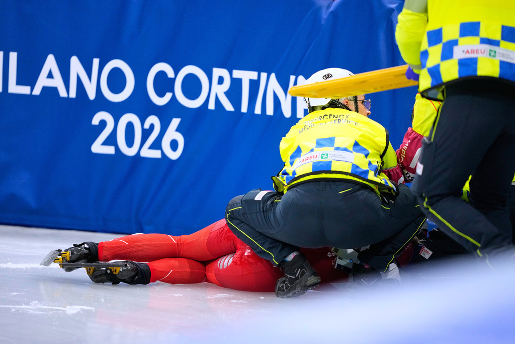 Kamila Sellier of Poland is helped after a fall during a short track speed skating women's 1500 meters quarterfinal at the 2026 Winter Olympics, in Milan, Italy, Friday, Feb. 20, 2026. (AP Photo/Natacha Pisarenko)