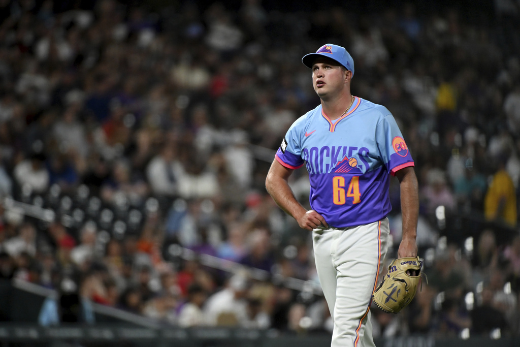 Colorado Rockies starting pitcher Bradley Blalock walks to the dugout after retiring the side in the fifth inning of a baseball game against the Los Angeles Angels, Friday, Sept. 19, 2025, in Denver. (AP Photo/Geneva Heffernan)
