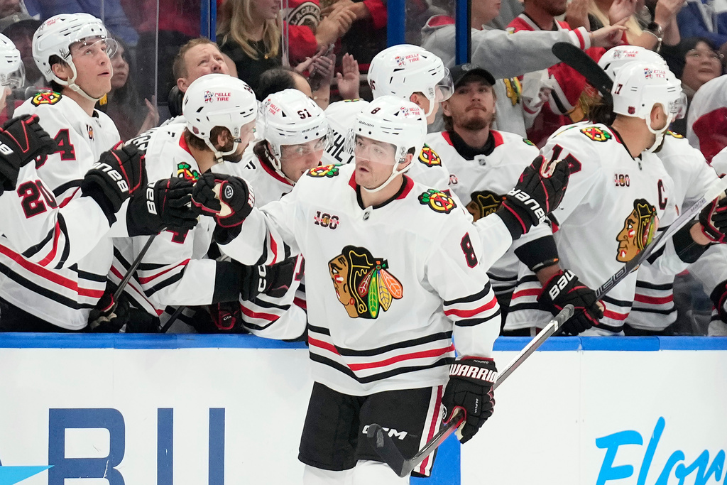 Chicago Blackhawks center Ryan Donato (8) celebrates with the bench after his goal against the Tampa Bay Lightning during the second period of an NHL hockey game Thursday, Oct. 23, 2025, in Tampa, Fla. (AP Photo/Chris O'Meara)