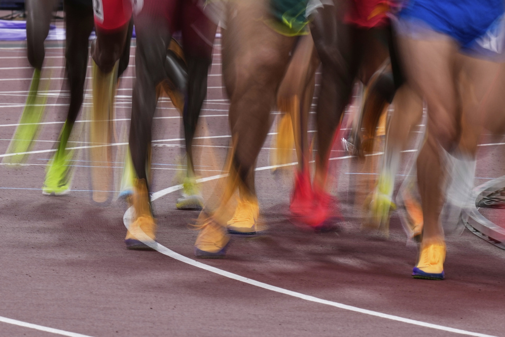 Athletes compete in men's 5,000 meters heat at the World Athletics Championships in Tokyo, Friday, Sept. 19, 2025. (AP Photo/Eugene Hoshiko)