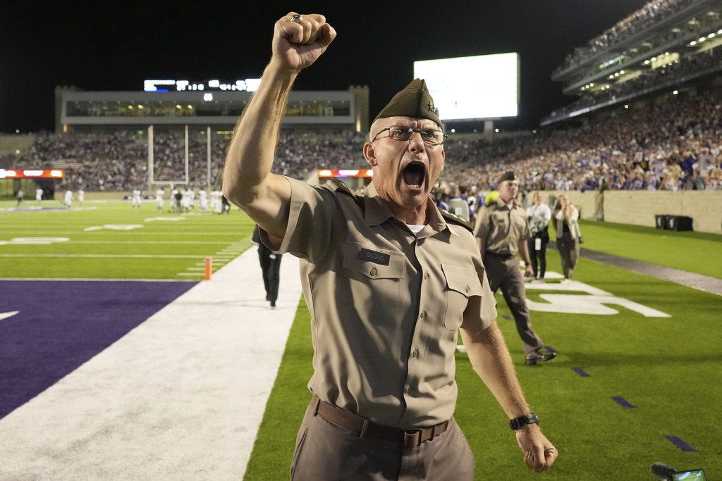 Westpoint commandant Lieutenant General Steven W. Gilland cheers after Army intercepted a pass late in the second half of an NCAA college football game against Kansas State, Saturday, Sept. 6, 2025, in Manhattan, Kan. (AP Photo/Charlie Riedel)