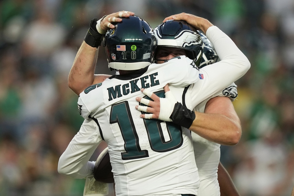Philadelphia Eagles quarterback Tanner McKee (16) celebrates his touchdown with teammates during the first half of an NFL preseason football game against the Cincinnati Bengals on Thursday, Aug. 7, 2025, in Philadelphia. (AP Photo/Matt Slocum)