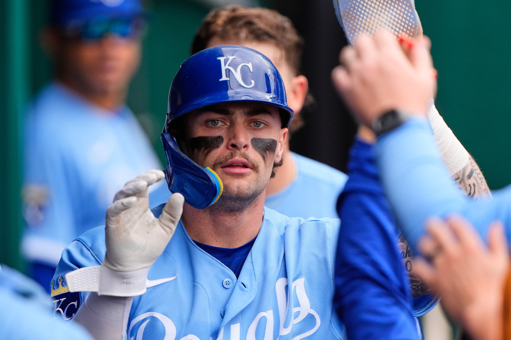 Kansas City Royals' Carter Jensen celebrates in the dugout after scoring on a single by Lane Thomas during the fourth inning of a baseball game against the Baltimore Orioles, Wednesday, April 22, 2026, in Kansas City, Mo. (AP Photo/Charlie Riedel)