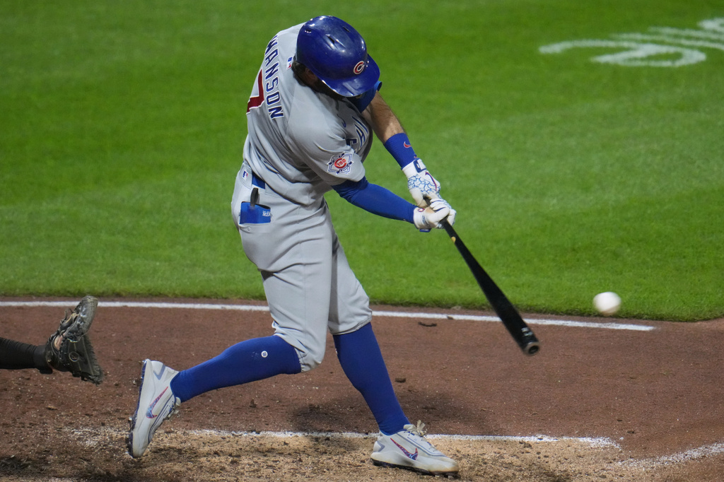 Chicago Cubs' Dansby Swanson singles off Pittsburgh Pirates pitcher Yohan Ramírez, driving in a run, during the tenth inning of a baseball game in Pittsburgh, Friday, July 24, 2026. (AP Photo/Gene J. Puskar)