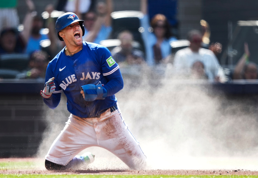 Toronto Blue Jays' George Springer reacts after scoring a run against the Houston Astros during the first inning of a baseball game in Toronto, Thursday, Sept. 11, 2025. (Nathan Denette/The Canadian Press via AP)