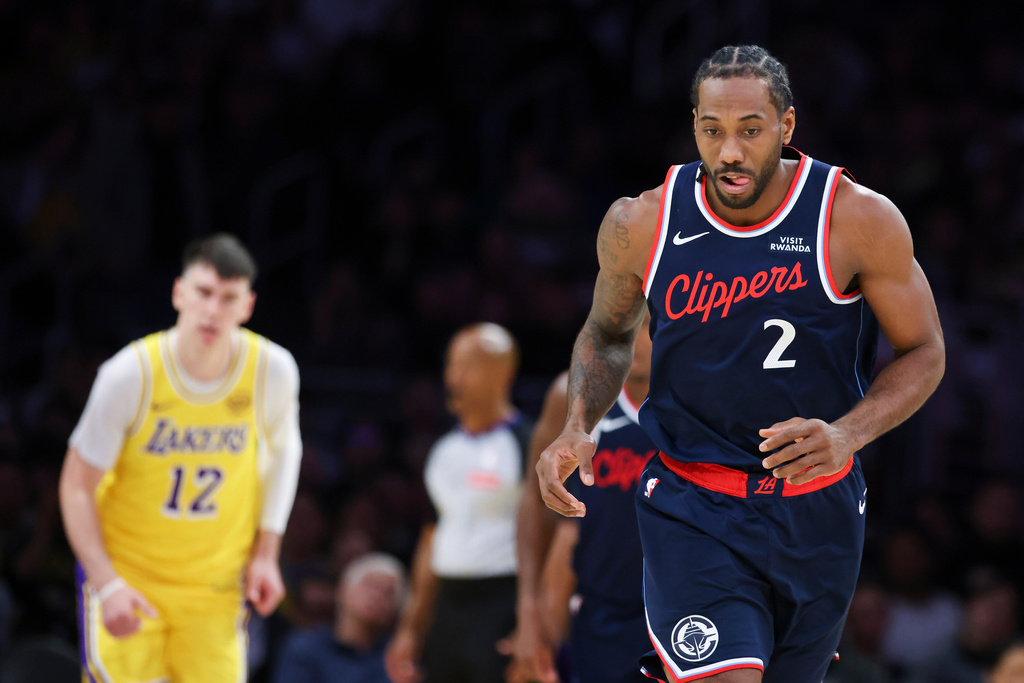 Los Angeles Clippers forward Kawhi Leonard (2) reacts after scoring as Los Angeles Lakers forward Jake LaRavia (12) watches during the first half of an NBA basketball game, Friday, Feb. 20, 2026, in Los Angeles. (AP Photo/Jessie Alcheh)