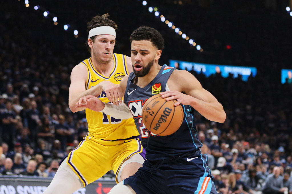 Oklahoma City Thunder guard Ajay Mitchell, front, works for a shot as Los Angeles Lakers' Austin Reaves, rear, defends in the second half of Game 2 in a second-round NBA basketball playoffs series Thursday, May 7, 2026, in Oklahoma City. (AP Photo/Nate Billings)