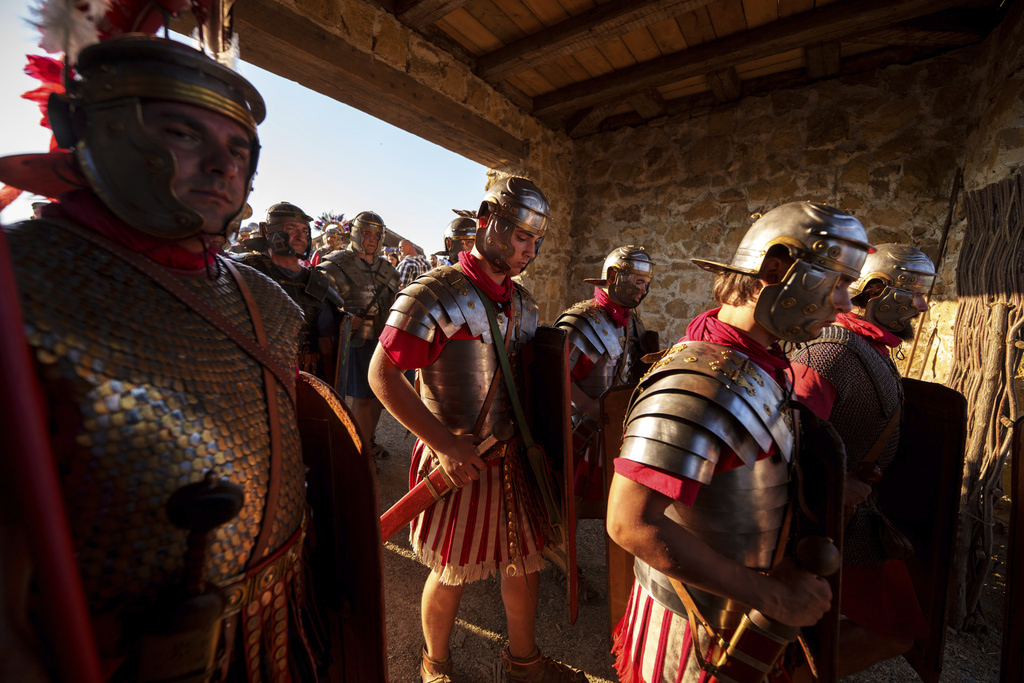 Members of historical reenactment groups wearing Roman soldier outfits, prepare to demonstrate Roman era warfare tactics in Poiana, Romania, Sunday, July 13, 2025, during the Getodava historical reenactment festival. (AP Photo/Vadim Ghirda)