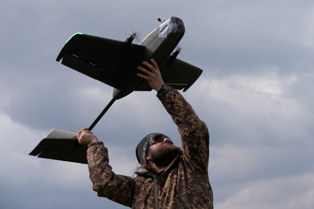 A student soldier of the Yatagan School for Unmanned Aerial Systems launches a training target drone during drills in the Kyiv region, Ukraine, Thursday, March 19, 2026. (AP Photo/Efrem Lukatsky)