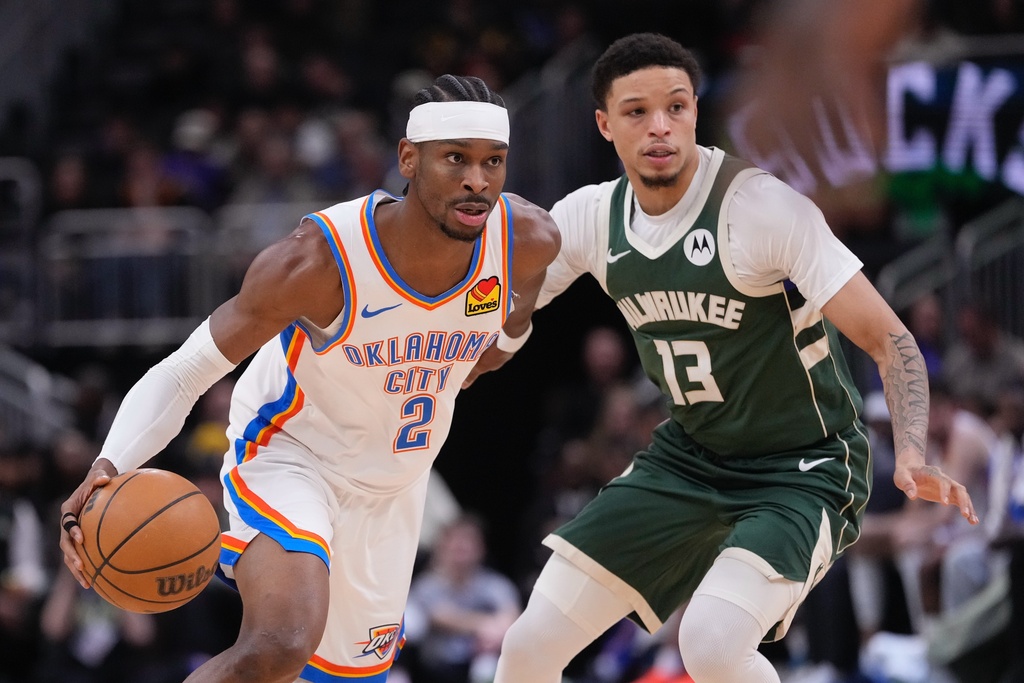 Oklahoma City Thunder's Shai Gilgeous-Alexander tries to get past Milwaukee Bucks' Ryan Rollins during the first half of an NBA basketball game Wednesday, Jan. 21, 2026, in Milwaukee. (AP Photo/Morry Gash)