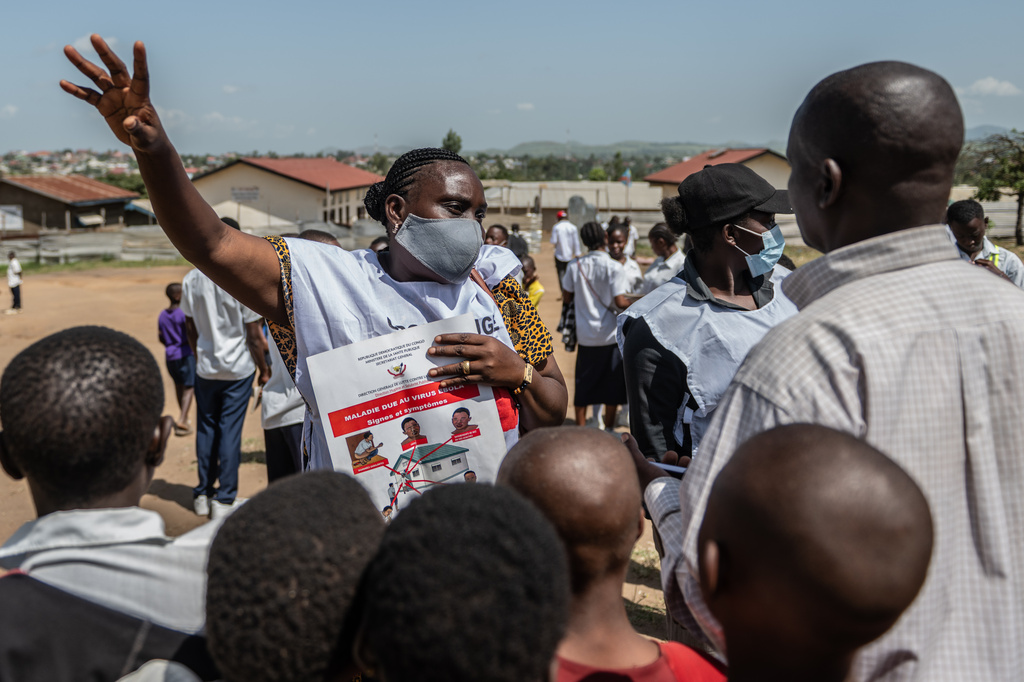 Vanny Birungi, a Red Cross volunteer, speaks to people during a public sensitisation campaign amid the Ebola outbreak in Bunia, Congo, Monday, May 25, 2026. (AP Photo/Moses Sawasawa)